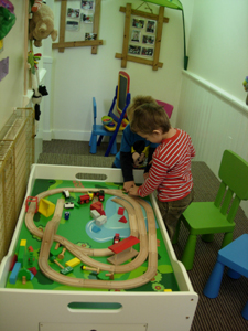 Pre-school children playing with a train set at Early Learners Nursery School, Leicester